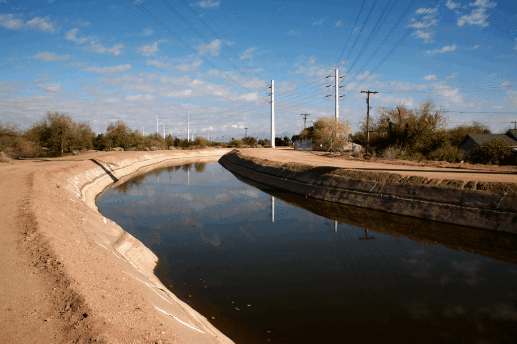 Water canal under a clear blue sky.