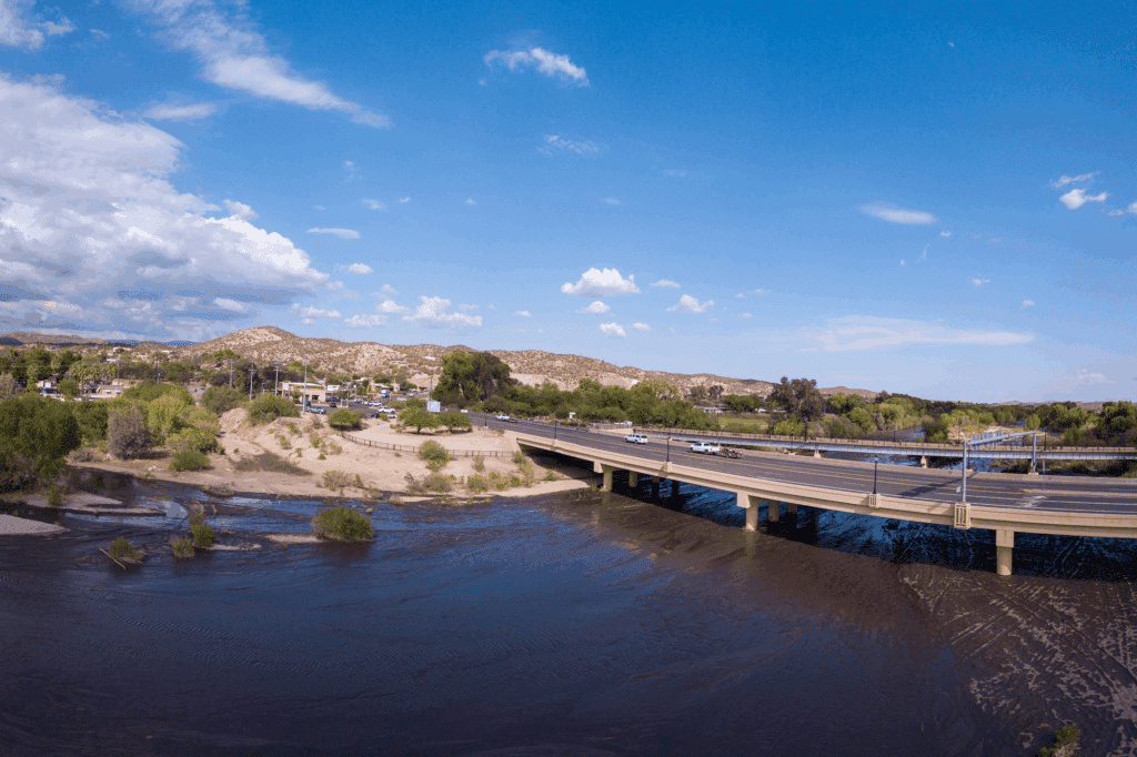 Bridge over river with distant hills.
