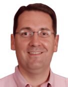 kent-Picsart-AiImageEnhancer Smiling person wearing glasses and a shirt.