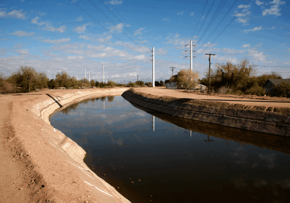 Water canal under a clear blue sky.