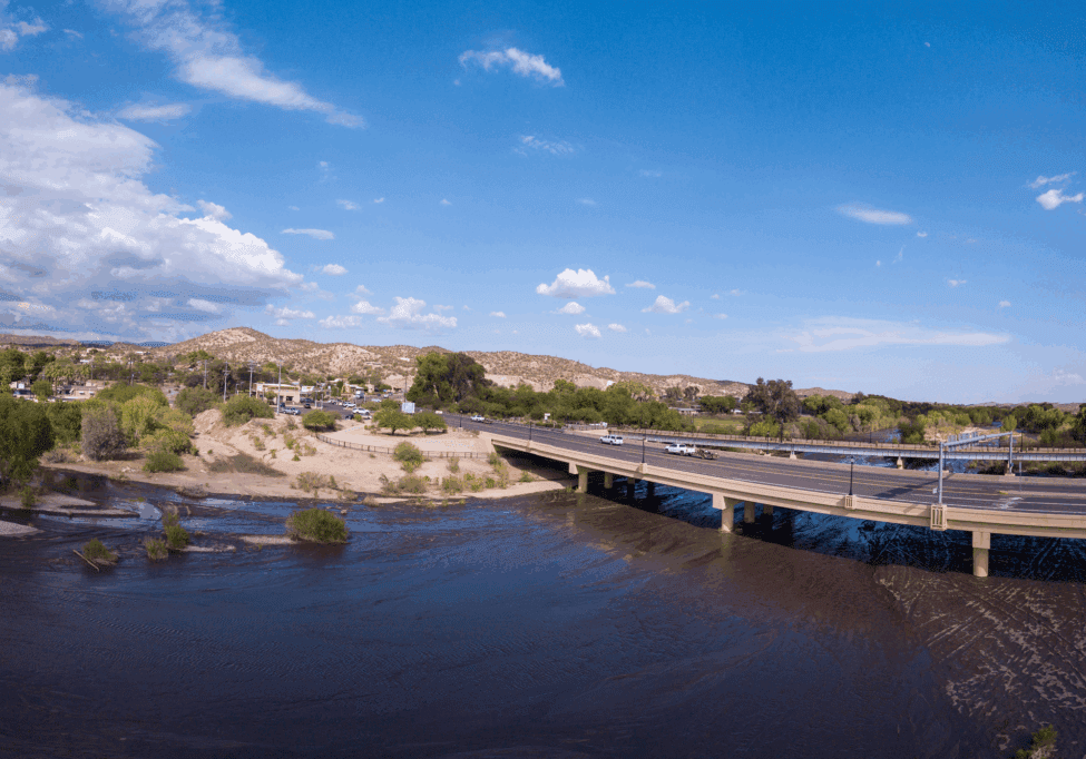 Bridge over river with distant hills.